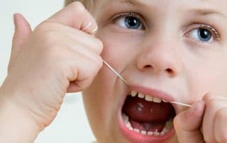 Boy flossing his teeth