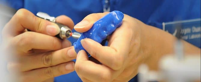 Dentist custom making a blue mouthguard