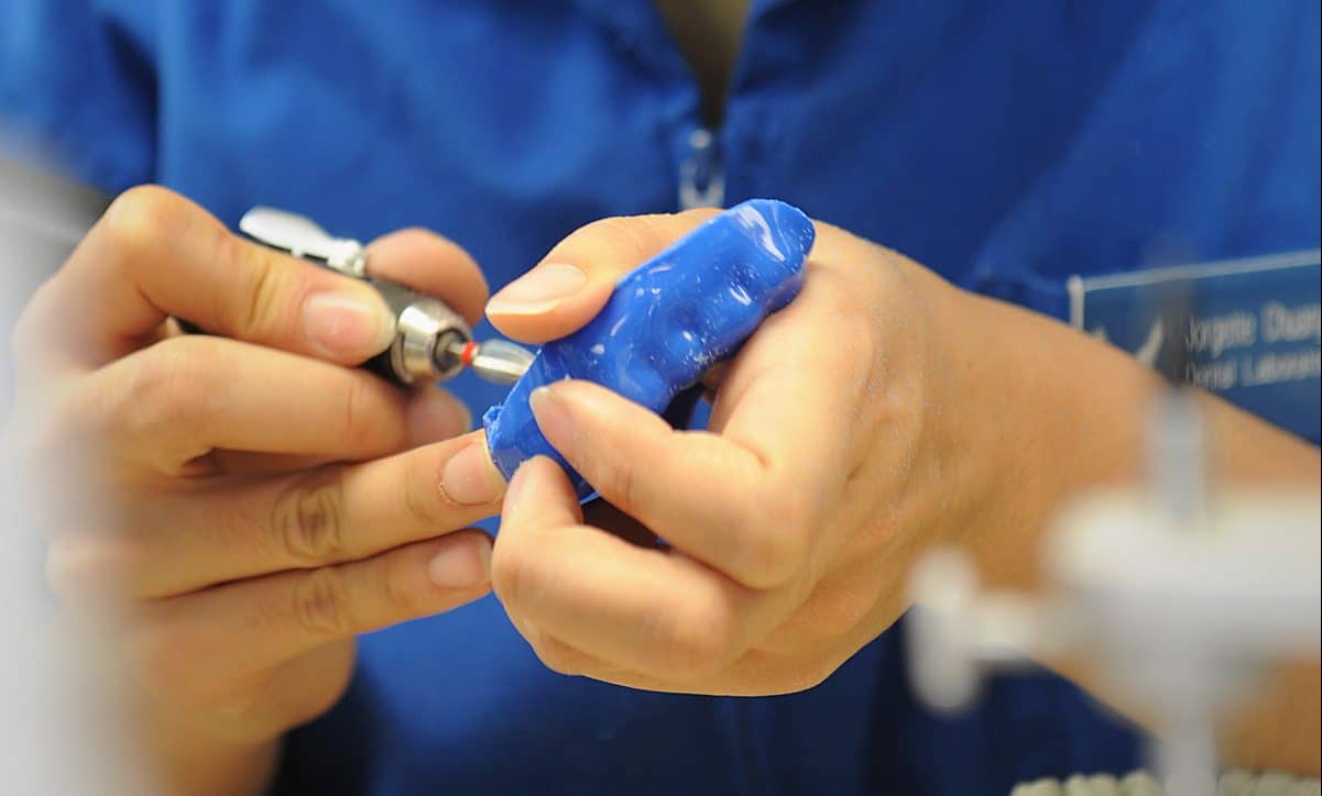 Dentist custom making a blue mouthguard